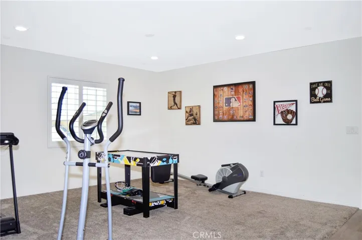This loft space can serve so many purposes: a home gym, game room, theater room, play room, home office, or ?