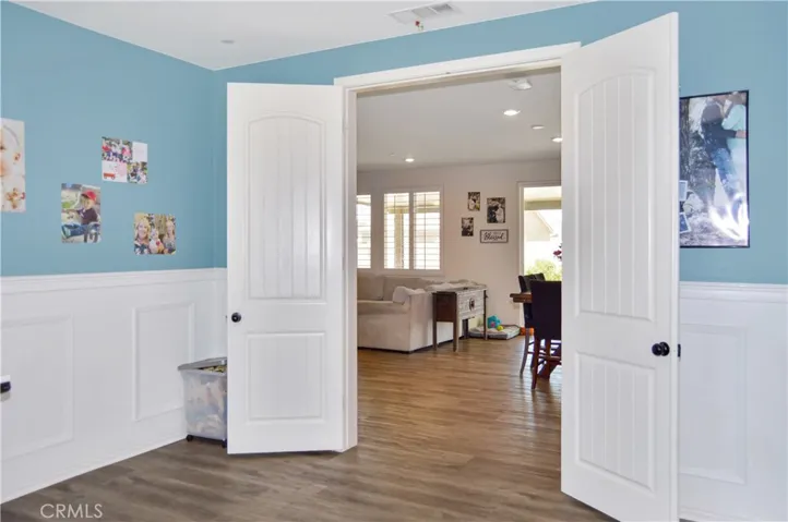 This attractive main floor office with double-door entry and stylish wainscoting can serve so many purposes. It can be a formal dining room, den, extra bedroom, or ?