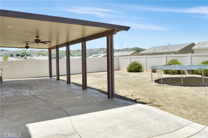 What a great backyard with an expansive stamped concrete patio partially covered by an AlumaWood cover with fans and recessed lighting and a nearly blank slate to landscape to your taste. Yes, this is a premium, pool-sized lot!