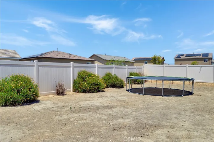 What a great backyard with an expansive stamped concrete patio partially covered by an AlumaWood cover with fans and recessed lighting and a nearly blank slate to landscape to your taste. Yes, this is a premium, pool-sized lot!