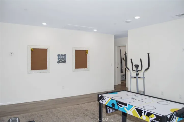 This loft space can serve so many purposes: a home gym, game room, theater room, play room, home office, or ?