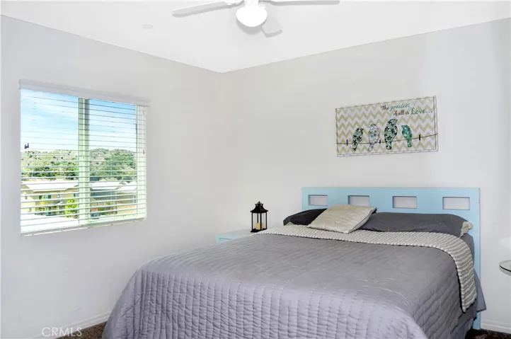 The 4th bedroom is right across from Bedroom #3 and offers nice views of the local hills to the south, a walk-in closet, a ceiling fan, and window blinds