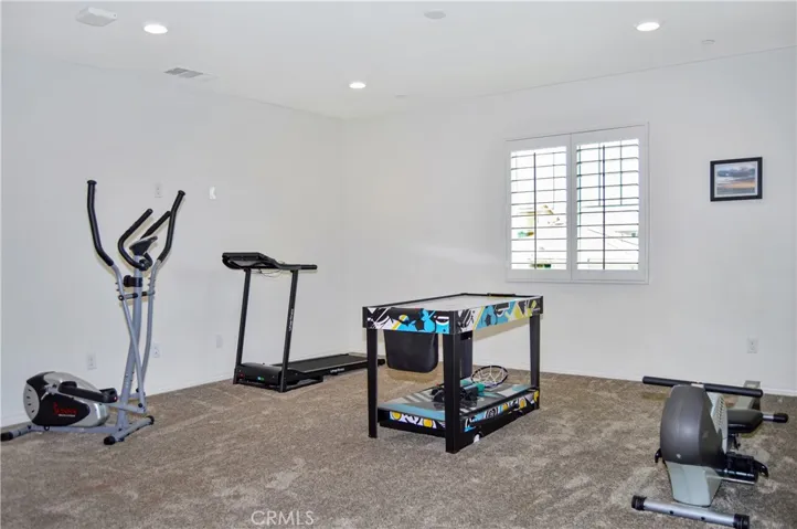 This loft space can serve so many purposes: a home gym, game room, theater room, play room, home office, or ?