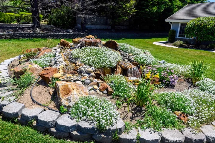 Water fall with flowers in front yard