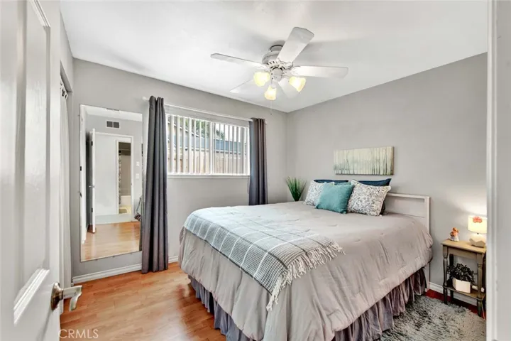 This bedroom has laminate flooring.