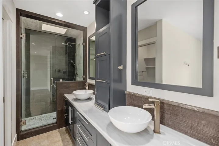 Primary Bathroom with shower and dual vanity sinks.