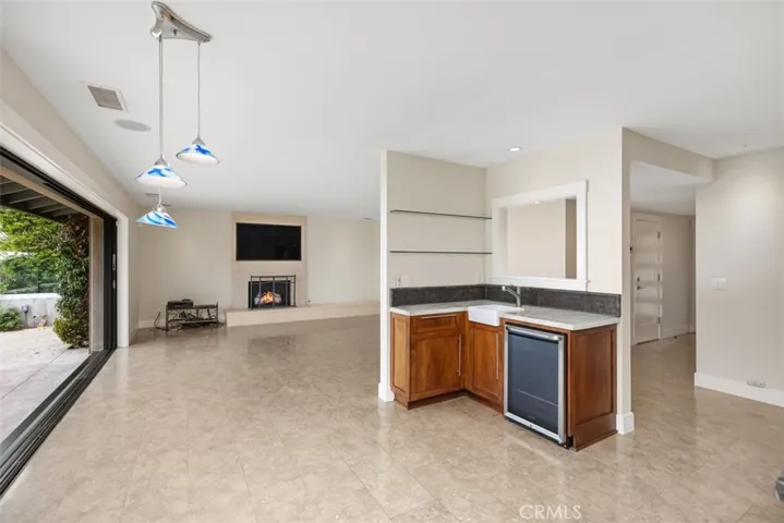Wet bar is located conveniently for entertaining with a beverage refrigerator.
