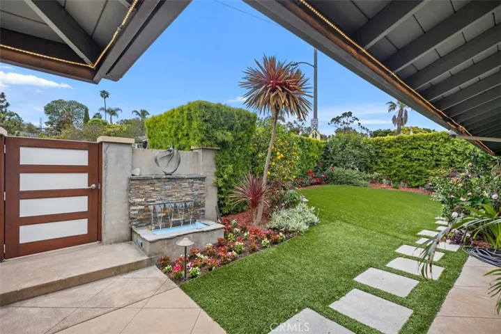 Private front yard with waterfall feature.