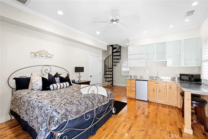 Casita looking to the interior with kitchenette and stairway to a bedroom.