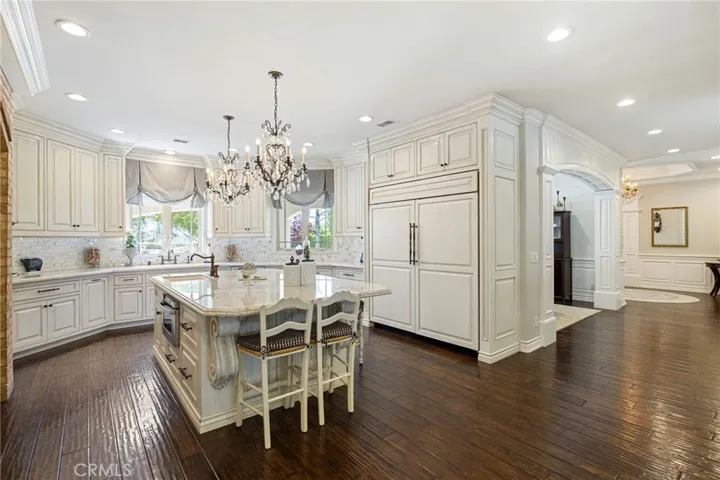 Wide angle of the kitchen with the hallway that leads to the formal dining room.