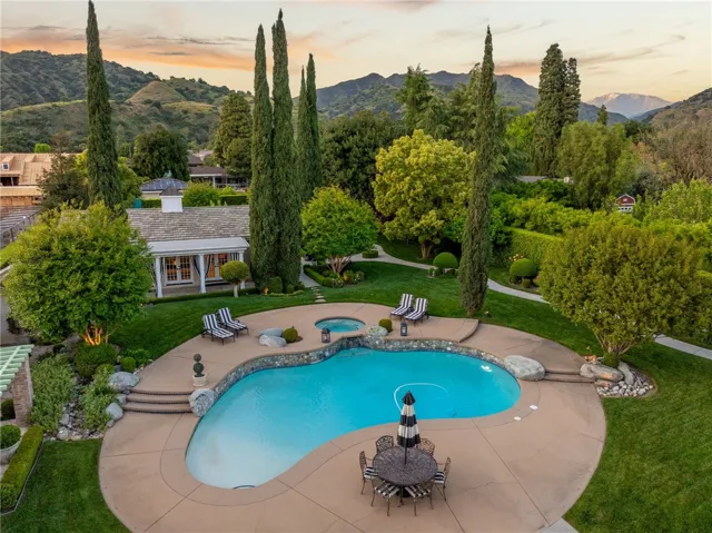 Aerial of the pool and pool house to the left.