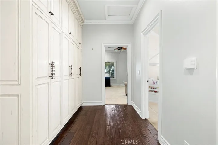 Opposite wing from the primary bedroom, this hallway leads to two spacious bedrooms with jack-and-jill bathrooms.