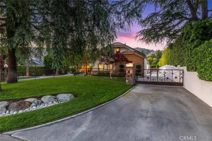 Second gated driveway that leads all the way past the back side of the home.