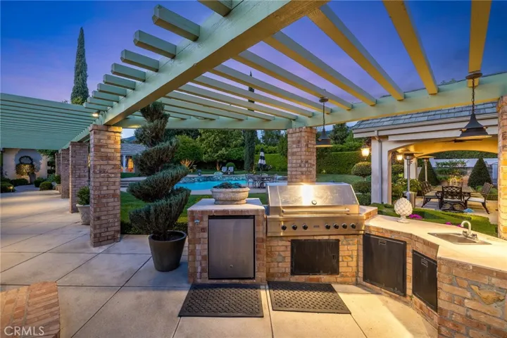 Built-in barbecue under a long covered patio that extends all the way down the walkway.