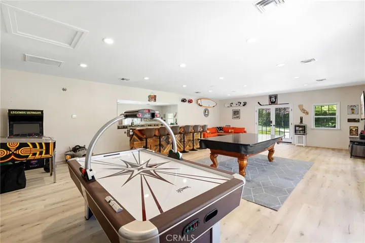 Interior of the pool house offering LVP flooring, recessed lighting, and HVAC.