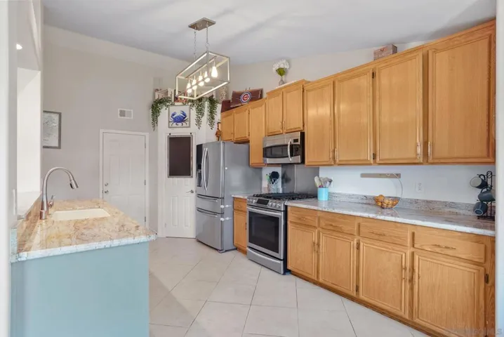 Large kitchen with breakfast bar, plenty of cabinets for storage, walk-in pantry, tons of counter space and direct access to 2-car garage to easily bring in groceries.