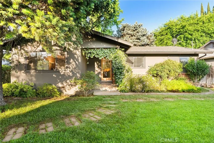 Nestled behind a 6 foot privacy fence, covered in Boston Ivy is this incredibly charming home