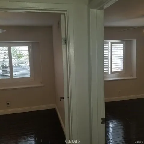 Here is a view of both secondary bedrooms complete with plantation shutters and ceiling fans