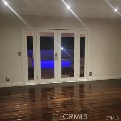 Here is a look at the French doors looking at the pool area at night