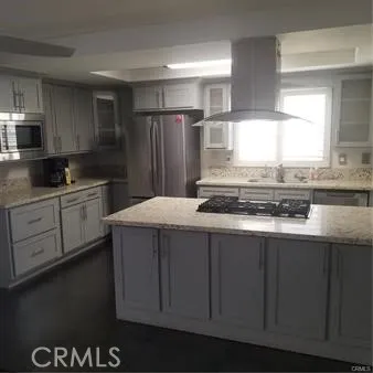 This remodeled kitchen has granite countertops and stainless steel appliances