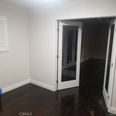 The den has decorative glass doors
