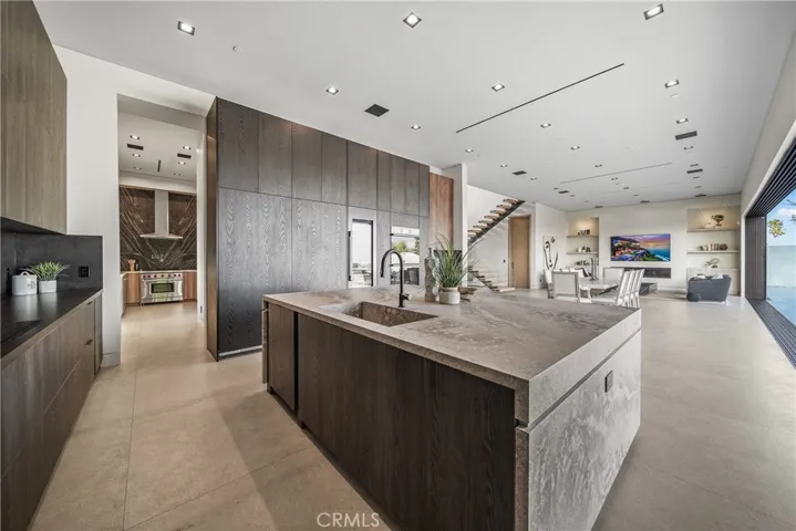 Entertainers Kitchen with full view over to dining room and living room.  Includes a hidden dishwasher, side by side hidden refrigerator and two hidden freezers.  Also includes a 100 bottle wine refrigerator.