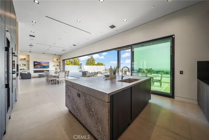 Entertainers Kitchen with full view over to dining room and living room.  Includes a hidden dishwasher, side by side hidden refrigerator and two hidden freezers.  Includes a 100 bottle wine refrigerator .