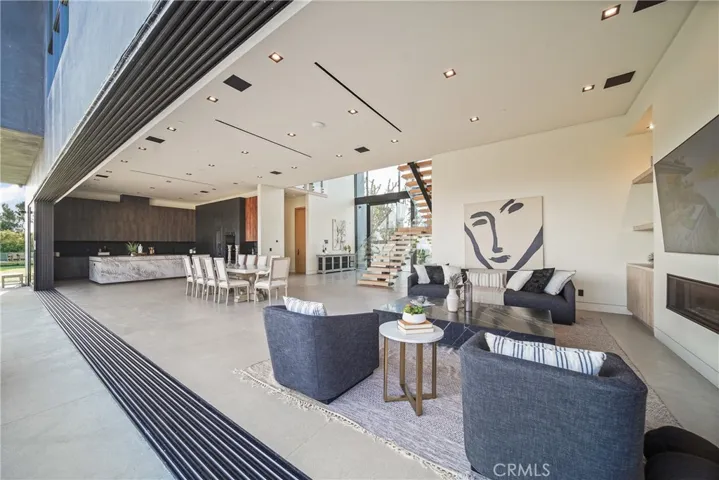 Downstairs living space offers indoor outdoor living with city, golf course and mountain views.