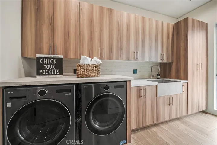 Laundry has two washer hook ups and two dryer hook up on each side of room.  There are two washer and two dryers in this laundry room located upstairs.
