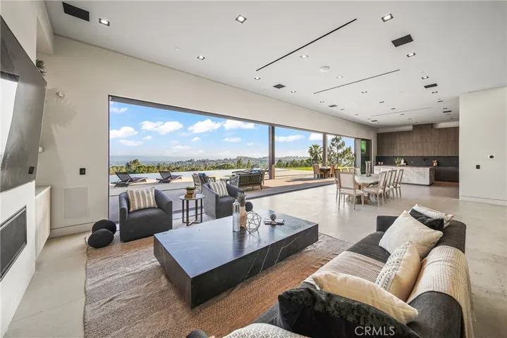 Downstairs living space offers indoor outdoor living with city, golf course and mountain views.