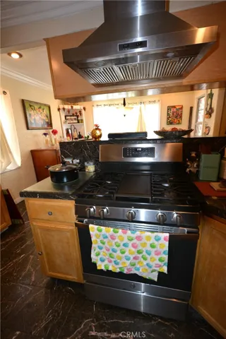 A lovely hood tops the gas burning range