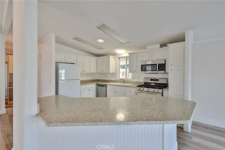 Kitchen with large counter space, breakfast bar, stainless appliances-