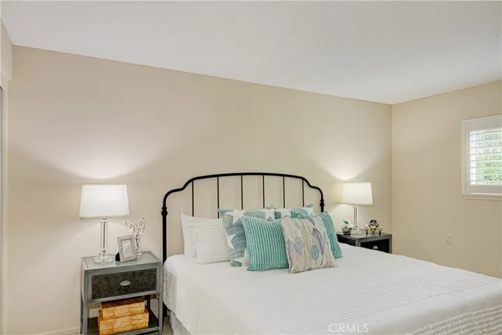 The primary bedroom is large and can accommodate a king size bed. The shutters give the room a comfortable, restful feeling.