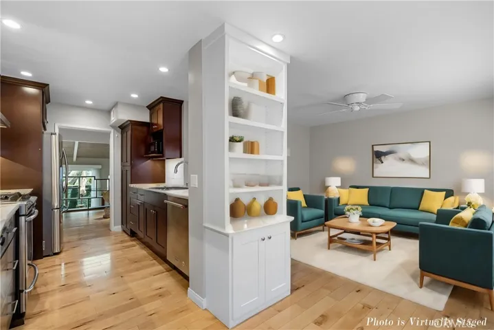 Kitchen is adjacent and open to the den. This Photo is virtually staged.