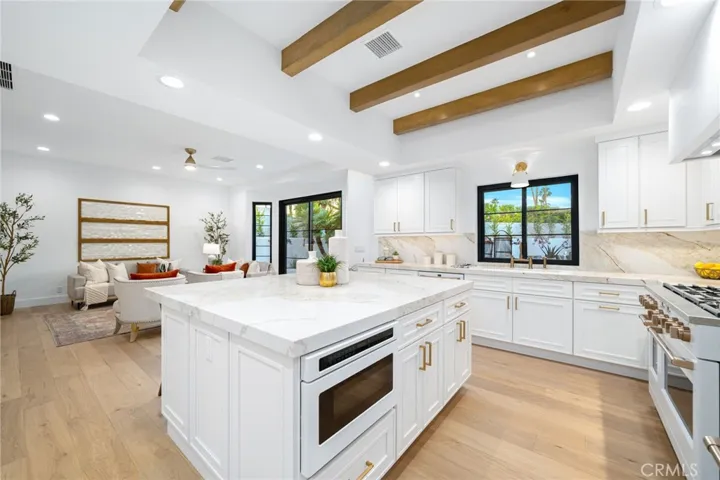 Chef’s Kitchen with spacious island, Café appliances and custom cabinetry
