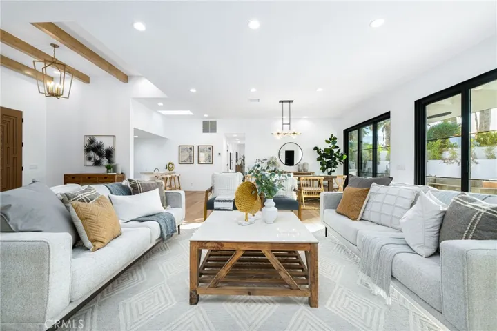 Large living room area offers a bar area + separate 120 bottle wine storage room.
