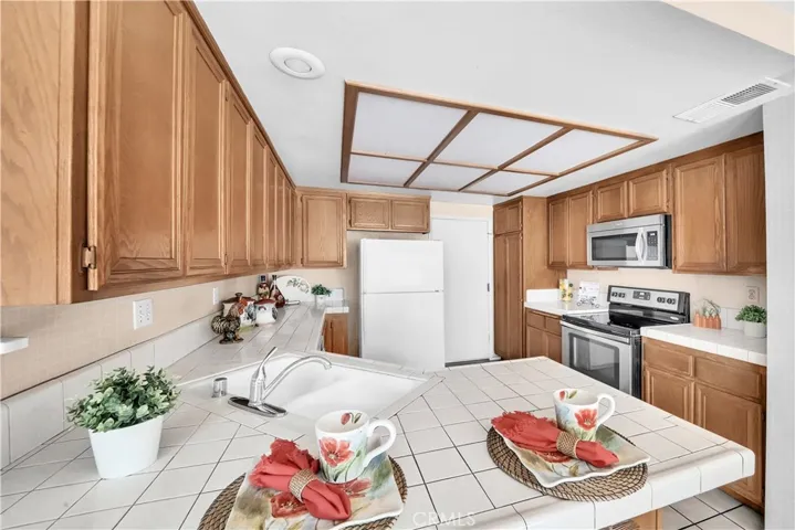 Kitchen Includes Tile Countertops, a Breakfast Bar, and and abundance of Cabinetry!