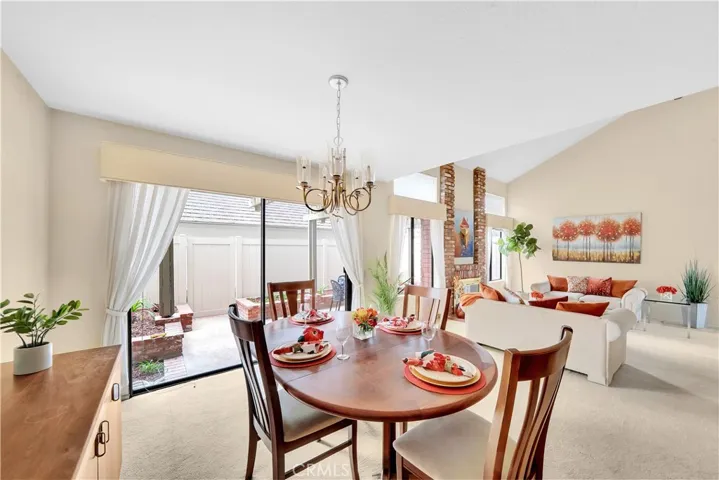 A Full size Dining room that is Open to Both the Living Room and the Kitchen with a Sliding Glass Door that Opens to the Patio!