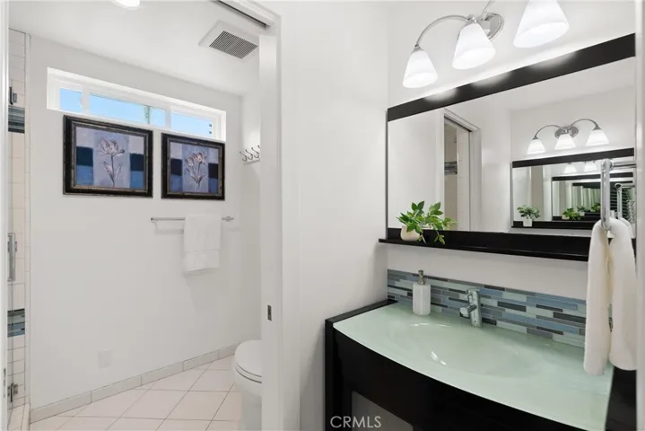 Between the 2 secondary bedrooms is this upgraded hall bathroom.  With dual, custom designed sinks and privacy door area for the remodeled walk-in shower.