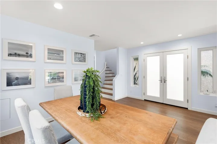 A view from the dining table towards the elegant, double door entry.