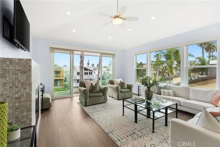 A view of the upstairs family room with vaulted ceilings, custom designed fireplace & more.