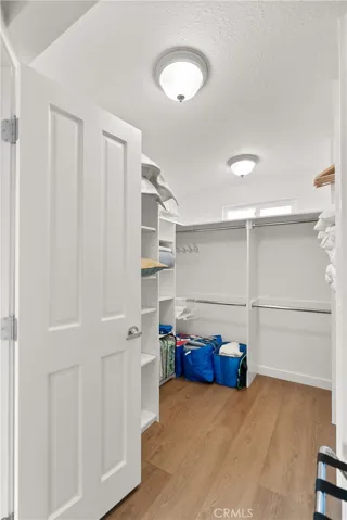 The walk-in closet with built-in organizers for the primary bedroom.