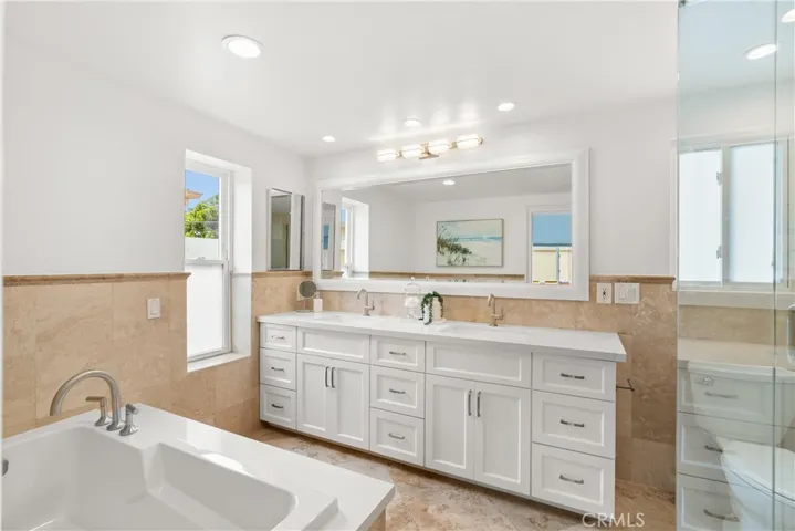 The ensuite primary bathroom boasts quality and style.