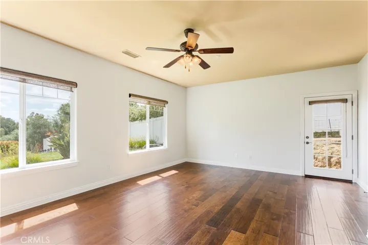 Primary bedroom has view windows and door to exterior.