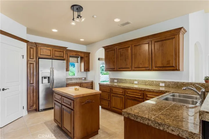 With granite counters, stainless appliances, island, separate wet bar area and plenty of storage space.