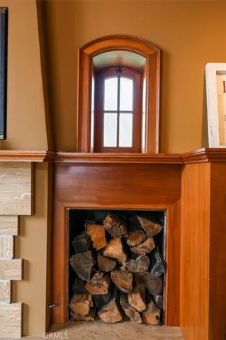Love this window nestled above the wood storage.
