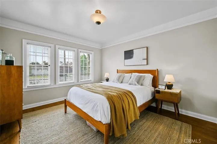 Front bedroom with original wood floors, moldings, windows (restored) and a walk-in closet.