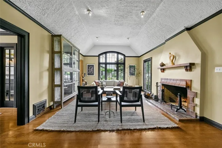 Original oak hardwood floors and original Batchelder tile fireplace.