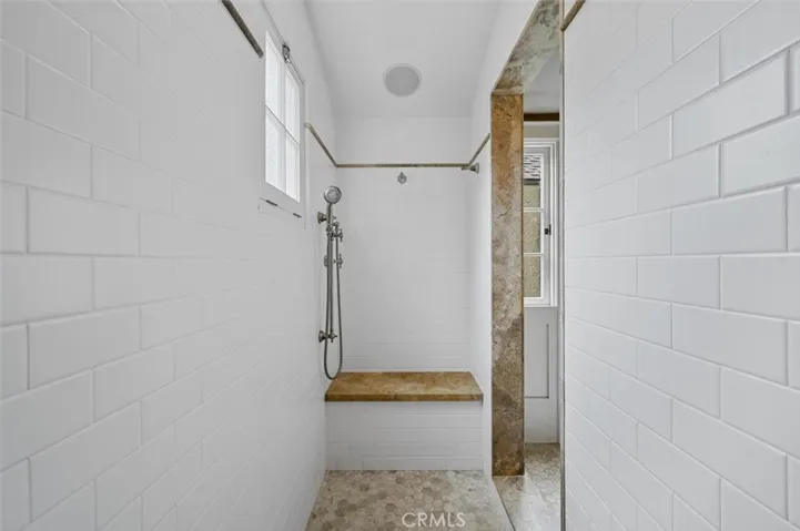 Large walk in shower with seat.