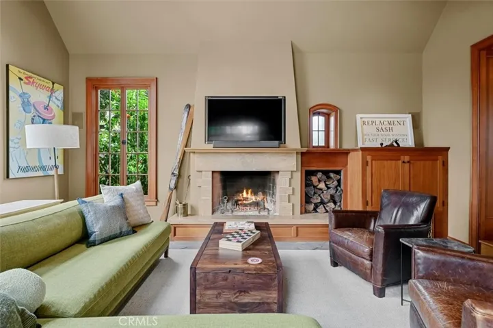 A cozy wood burning fireplace and TV are the center of this room.